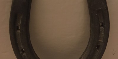 A metal horseshoe in a U-shape.