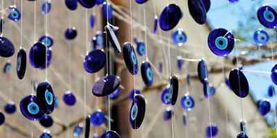 Dozens of evil eye talisman decorations hanging on strings.