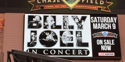 A billboard sign for a Billy Joel concert at Chase Field in Phoenix, Arizona