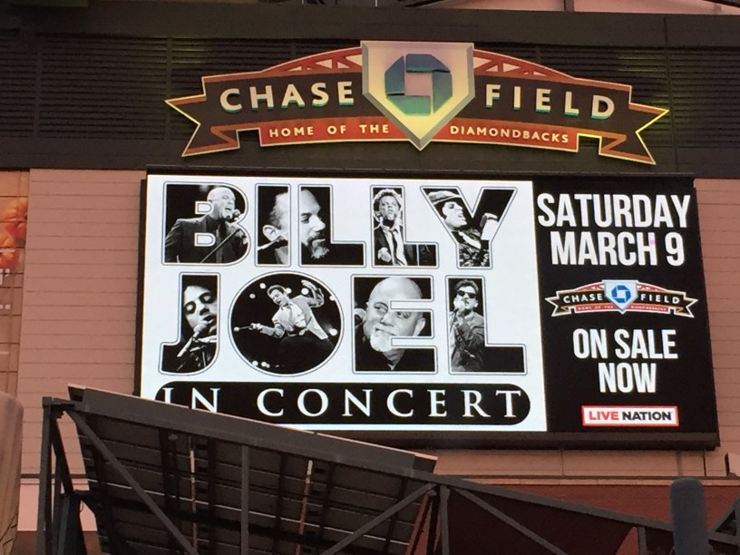 A billboard sign for a Billy Joel concert at Chase Field in Phoenix, Arizona