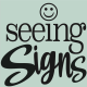 Seeing Signs logo with a smiley face above the letter i in the word seeing