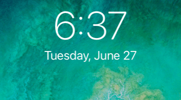 The time and date on a cell phone with a cloudy green background. The time is six hours and thirty-seven minutes and the date is Tuesday, June twenty-seventh.