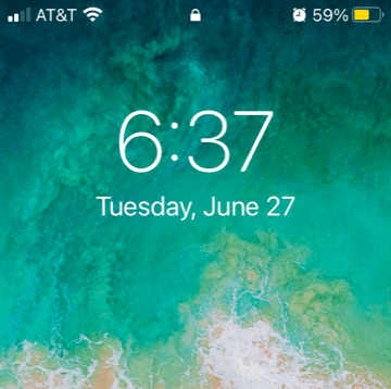 The time and date on a cell phone with a cloudy green background. The time is six hours and thirty-seven minutes and the date is Tuesday, June twenty-seventh.