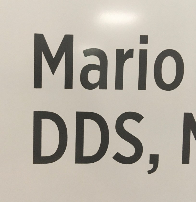 An off-white background with the the name Mario in black type and below it the initials D, D, S.