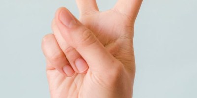 A peace sign made with the first two fingers forming a V and the thumb and other two fingers folded into the palm of the hand.