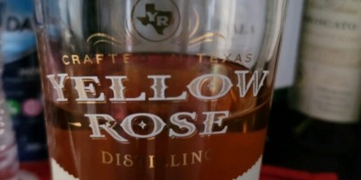 Bottle of half full Yellow Rose whiskey.