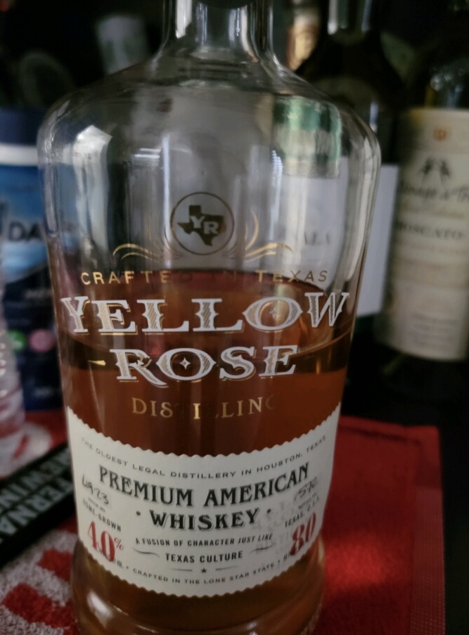 Bottle of half full Yellow Rose whiskey.