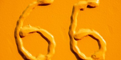 Two yellow raised sixes on a yellow background.