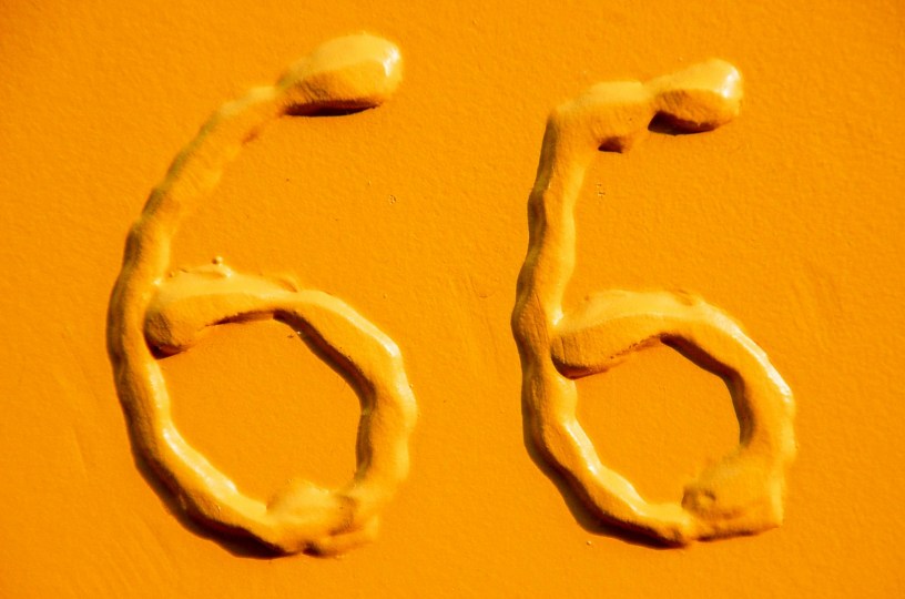 Two yellow raised sixes on a yellow background.