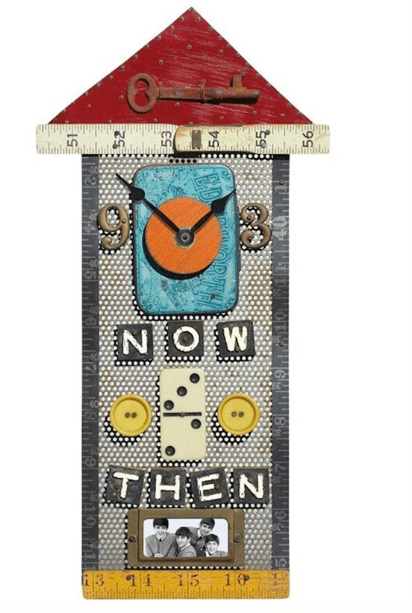 An artsy clock shaped like a house has a red triangle roof with a rusty old-fashioned key in the middle and tape measure outlining the rectangular house. The house has the clock element with a metal 9 and 3. Below that is the word “now.” Underneath that is a domino flanked by two buttons and under that is the word “then.” At the bottom is a black and white photograph of the Beatles from the 1960s.
