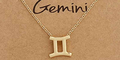 A gold Gemini zodiac sign pendant on a chain with the word Gemini between the chain and underneath the date May 21 to June 20.