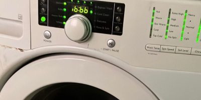 A white front load washing machine with the number 666 displayed.