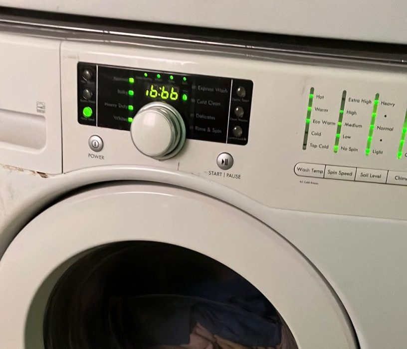 A white front load washing machine with the number 666 displayed.